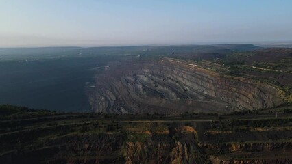 Wall Mural - Panorama aerial view shot open pit mine coal mining, dumpers, quarrying extractive industry stripping work. Big Yellow Mining Trucks. View from drone at opencast mining with lots of machinery trucks