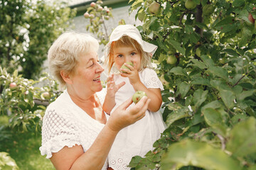 Wall Mural - Grandmother and granddaughter enjoyed in the garden