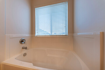 Wall Mural - Alcove square bathtub with wall-mounted faucet and window with blinds. Acrylic white square bathtub with stainless steel faucet fixture.