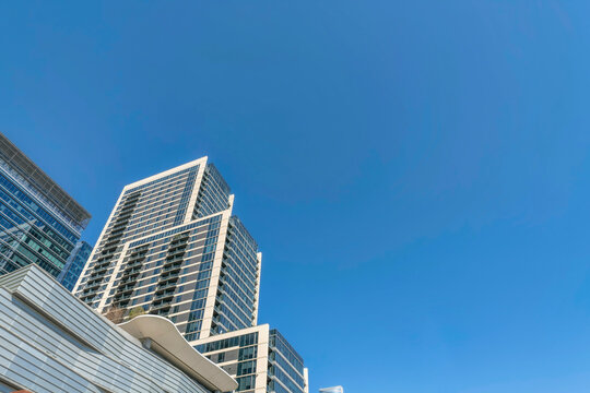 austin, texas- view of a layered building with glass exterior from below, low angle view of a buildi