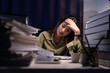Woman working overtime on a desk at night