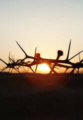 the cross, crown of thorns, nails and red sunset symbolizing the sacrifice and suffering of jesus ch