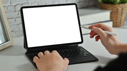 Creative man hand holding stylus pen and pointing on digital tablet screen. Cropped shot