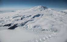 Aerial Image Of Mount Erebus Antarctica With Erebus Bay In The Foreground.