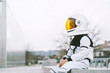 © Westend61 - Boy wearing astronaut costume sitting on seat