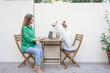 © Westend61 - Freelancer and dog with laptop sitting on table by wall