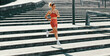 © Jacob Lund - Sports woman running down the stairs outdoors in the morning