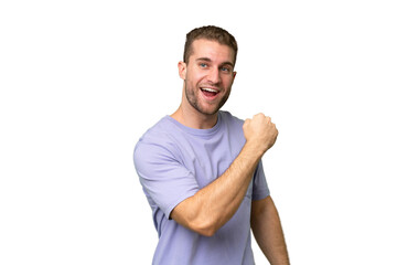 Wall Mural - Young handsome caucasian man isolated on green chroma background celebrating a victory