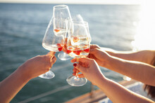 Sunset Sky And Sea On The Background. Making A Celebratory Toast With Sparkling Wine