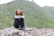 © Antonioguillem - Happy hiker sitting on a rock contemplating views