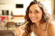© Antonioguillem - Happy woman in a coffee shop eating potatoe