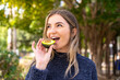 © luismolinero - Young pretty Romanian woman holding an avocado at outdoors