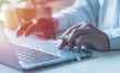 © chiew - Businessman hands using laptops for streaming online on virtual screens, watching videos on the internet, live concert, show or tutorial, and content online. .