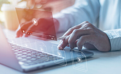 Businessman hands using laptops for streaming online on virtual screens, watching videos on the internet, live concert, show or tutorial, and content online. .