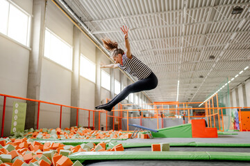 Wall Mural - Pretty girl in trampoline park having fun