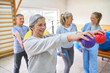 © Robert Kneschke - Elderly woman exercising with massage ball at rehab center