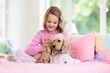 © famveldman - Child, dog and cat. Kids play with puppy, kitten.