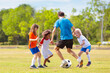 © famveldman - Kids play football. Child at soccer field.