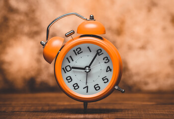 Wall Mural - Orange Alarm Clock On The Vintage Background