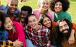 © PintoArt - group of multiracial people having fun outdoors. diverse people hugging and enjoying the holidays.