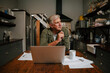 © Prins Productions - Caucasian senior male working at home sitting in kitchen