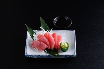 Wall Mural - Tuna sashimi isolated in black background