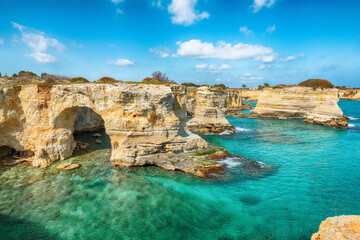 Stunning seascape with cliffs rocky arch and stacks (faraglioni) at Torre Sant Andrea