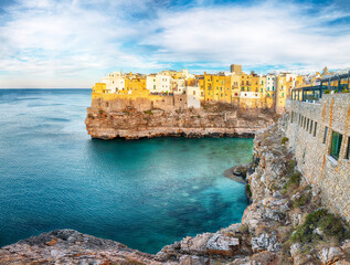 Poster - Amazing view on Polignano a Mare village on the rocks at sunset.