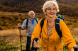 © Zoran Zeremski - Active senior couple with backpacks hiking together in nature on autumn day.
