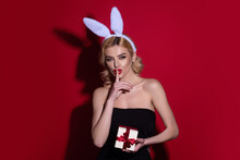 Portrait Of A Sexy Girl Celebrating Easter Isolated Over Studio Background. Studio Photo Of A Young Sensual Woman Wearing Bunny Ears. Festive Bunny.
