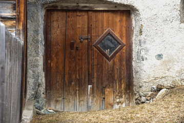 old wooden door in a farm house in the swiss Alps