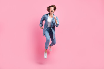 Sticker - Full length photo of impressed adorable lady dressed denim jacket hurrying jumping high isolated pink color background