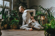 © lithiumphoto - Yoga instructor practicing asana indoor sitting on wooden floor