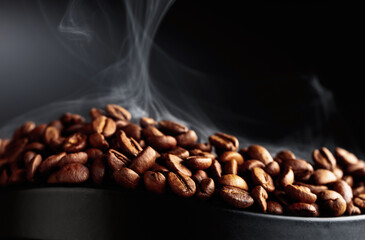 Steaming coffee beans on a black background.