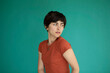 © VISTA by Westend61 - Young woman with short hair against green background