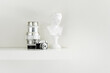 © Toyakisfoto.photos - A few small decorative objects and a vintage mini camera on a plain white wooden shelf