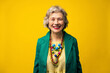 © VISTA by Westend61 - Happy senior woman wearing blazer against yellow background