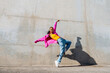 © VISTA by Westend61 - Young hip hop dancer dancing in front of wall