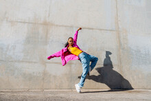 Young Hip Hop Dancer Dancing In Front Of Wall