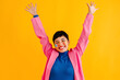 © VISTA by Westend61 - Happy young woman with arms raised standing over colored background