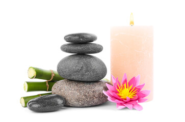 Wall Mural - Stack of spa stones, bamboo stems, flower and candle isolated on white