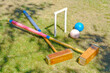 hoop, 2 malletts and 2 balls from a game of Croquet in a garden