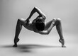 Young gymnast girl stretching and training. Beauty flexible dancer posing in studio