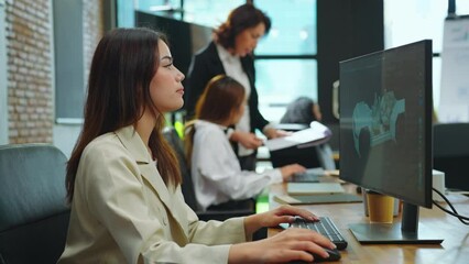 Female designer using computer to design ev car prototype at office. She used a 3D model to create a car model.