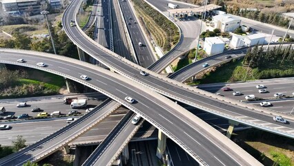 Wall Mural - Aerial drone rotational video of modern multilevel junction with crossing bridges, passing through National road of Athens and Attiki odos motorway