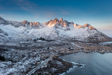 Wall Mural - Snow covered mountain range on coastline in winter, Norway. Senja panoramic aerial view landscape nordic snow cold winter norway ocean cloudy sky snowy mountains. Troms county, Fjordgard 