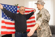 © Angelov - an elderly father and a military son saluting American flag