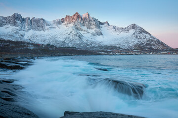 Wall Mural - Snow covered mountain range on coastline in winter, Norway. Senja panoramic aerial view landscape nordic snow cold winter norway ocean cloudy sky snowy mountains. Troms county, Fjordgard 