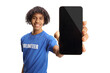 © Ljupco Smokovski - Young african american male volunteer holding a smartphone