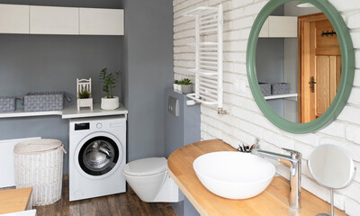 Wall Mural - Modern bathroom interior with ceramic wash basin on wooden counter with faucet and round mirror on white brick wall. Banner.